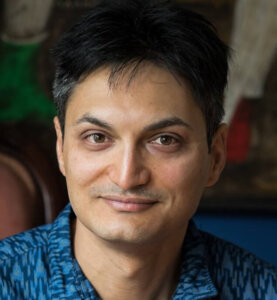 Portrait of a man in blue patterned shirt at HUA