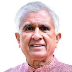 Headshot portrait of Shri Dilip Ji in pink kurta on white background