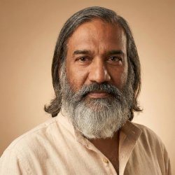 Shri Raghu Anantha Narayanan, HUA Yoga Studies faculty, in a close-up portrait on beige background
